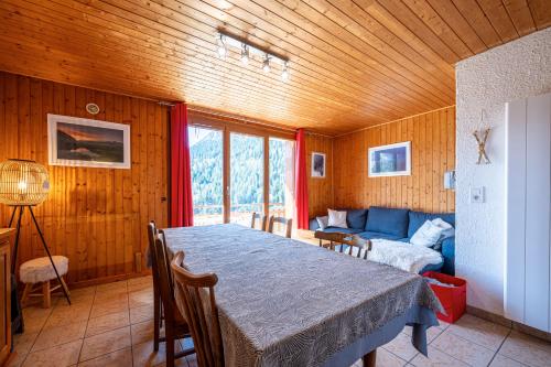 une salle à manger avec une table et un canapé dans l'établissement L'appartement Edelweiss, à Aillon-le-Jeune