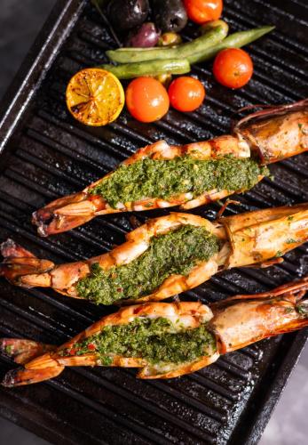 a group of fish and vegetables on a grill at Hyatt Ronil Goa - a JdV by Hyatt Hotel in Calangute