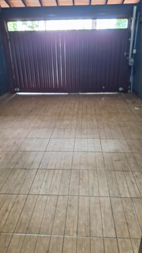 a room with a wooden floor and a wooden wall at Casa mobiliada para até 14 pessoas in Ribeirão Preto
