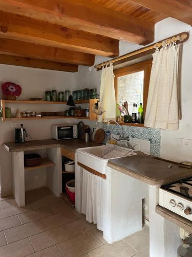 a kitchen with a sink and a stove at La rivière in Curvalle