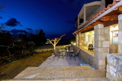 a patio with a table and chairs at night at Casa Di Aspa in Rethymno Town