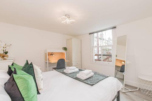 a white room with a bed and a window at Flat 3, 158 Abingdon Road in Oxford