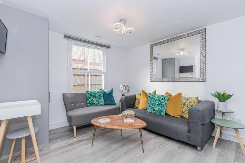 a living room with a couch and a table at Flat 3, 158 Abingdon Road in Oxford