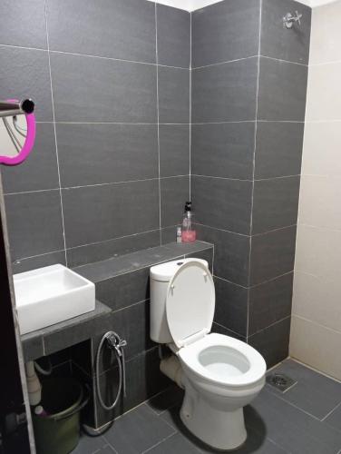 a bathroom with a toilet and a sink at DikMin Studio Apartment Pool and Netflix in Gua Musang