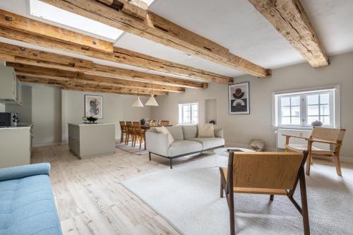a living room with a couch and a table at Stylish loft in the heart of CPH in Copenhagen