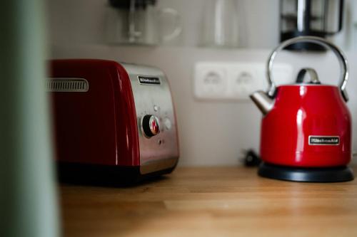 a red toaster sitting on top of a kitchen counter at Gut Zahren in Gallin