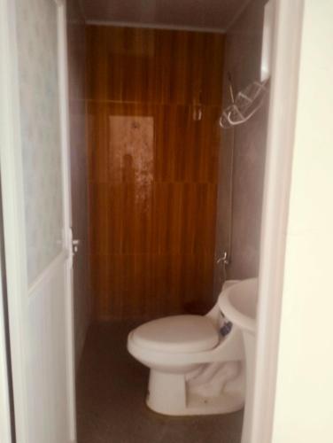 a bathroom with a white toilet and a sink at F1 Green Meadows Resort in Arnedo