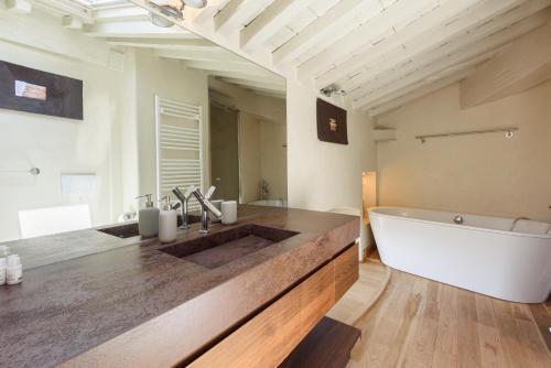 a bathroom with a tub and a sink and a bath tub at GOLDEN LUXE - Botero Loft Design Penthouse in Pietrasanta