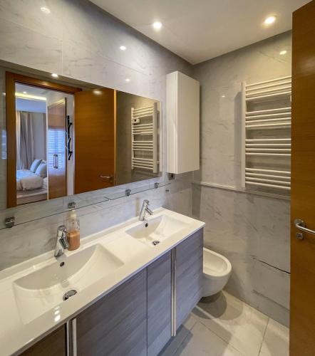 a bathroom with a sink and a toilet and a mirror at Pearl Chic Stay Pool and View in Rabat