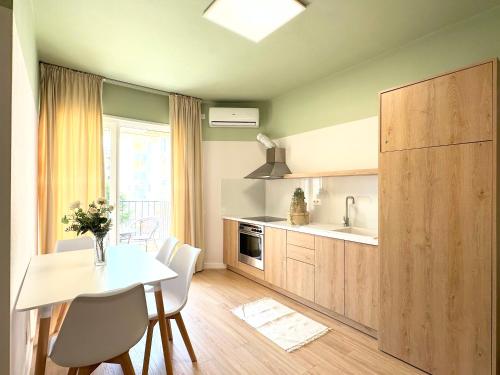 a kitchen with a table and a dining room at PROMO Cozy Apartments in Golem