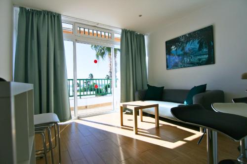 a living room with a couch and a table at Apartamentos Guanarama in Puerto del Carmen