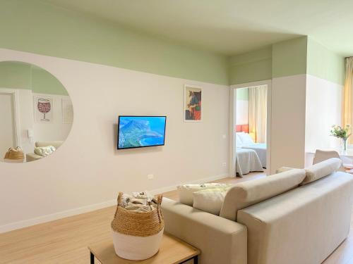 a white living room with a couch and a bed at PROMO Cozy Apartments in Golem