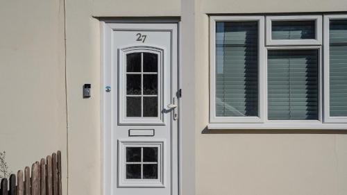 a white door with a window on a house at Spacious Bromley Home w Free parking and Outside Dining in Bromley