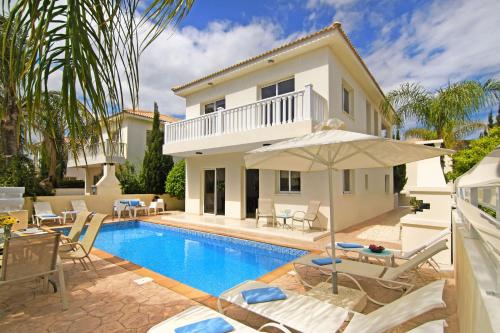 a villa with a swimming pool and a house at Nissi Sapphire Villa in Ayia Napa
