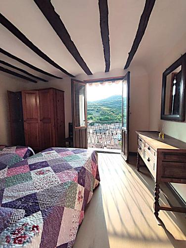 a bedroom with a bed and a dresser and a window at Mirador del Buitre in Soto en Cameros