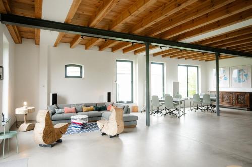 a living room with a couch and a table and chairs at Gut Zahren in Gallin