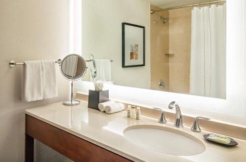a bathroom with a sink and a mirror at Sheraton Boston Needham Hotel in Needham