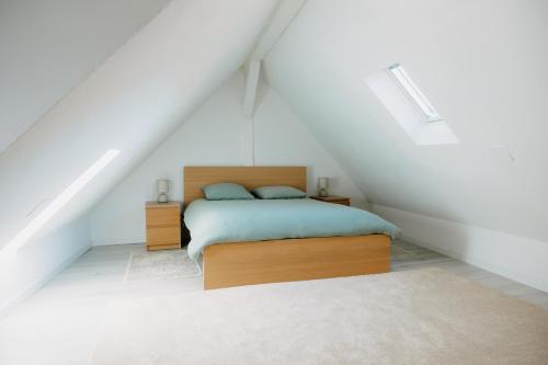 a bedroom with a bed in a attic at Sewwa Guest House in Sélestat