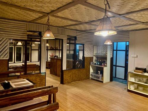 a room with two pendant lights and a kitchen at MayaTels - Maya Eco Huts, Pelling in Pelling