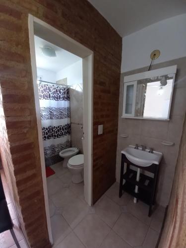 a bathroom with a toilet and a sink at Terraza al Mar in Las Grutas
