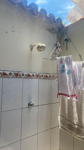 a bathroom with a shower with a towel at Condomínio azul in Paraty