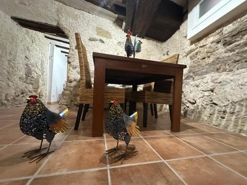 two chickens standing on a table in a room at casa rural las mariposas in Lerín