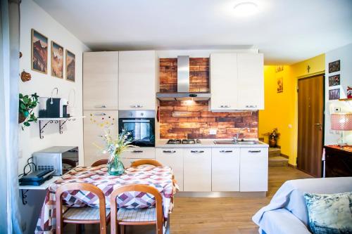 a kitchen with a table with a vase on it at Il Borghetto in Lanzo dʼIntelvi