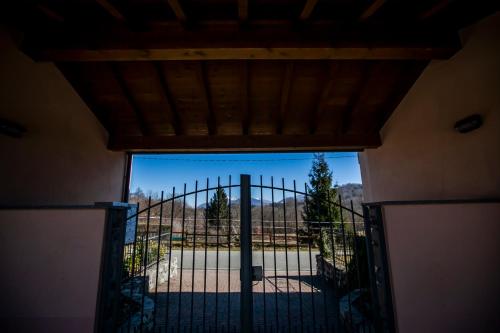 an open door to a gate with a view at Il Borghetto in Lanzo dʼIntelvi