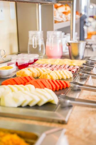 a bunch of food on a grill in a kitchen at EL SHADDAI HOTEL in João Pessoa
