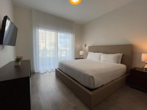 a bedroom with a large bed and a television at A Fantastic apart with balcony and partial view of the beach 4 Px in Hollywood