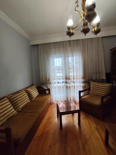 a living room with two couches and a window at Σπίτι τετράκλινο με θεα Φλώρινα in Florina