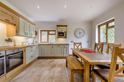 a kitchen with a table and a dining room at Finest Retreats - The House at No 47 in West Wickham