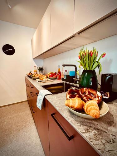 a kitchen with a plate of bread on a counter at New Studio with Sunny Terrace & Air Condition in Zürich