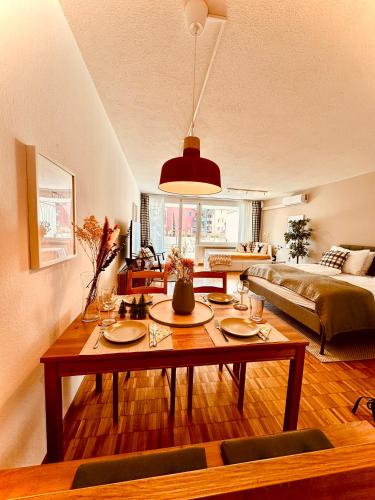 a living room with a table and a couch at New Studio with Sunny Terrace & Air Condition in Zürich