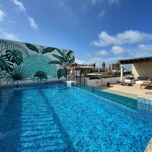 a large blue swimming pool on top of a building at Hotel Zendero Tulum in Tulum