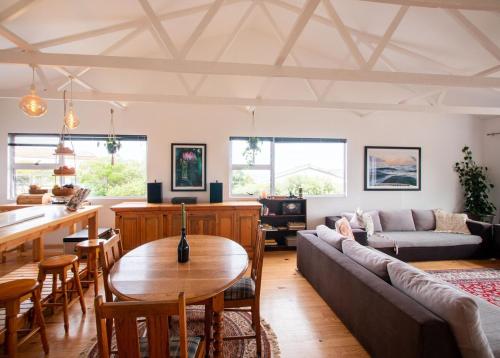 a living room with a couch and a table at LaVidaLekker in Brenton-on-Sea