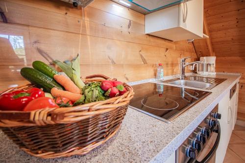 a kitchen with a basket of vegetables on a counter at Weingut und Ferienhof Josef Huber in Oberkirch