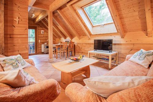 a living room with two couches and a tv in a cabin at Weingut und Ferienhof Josef Huber in Oberkirch