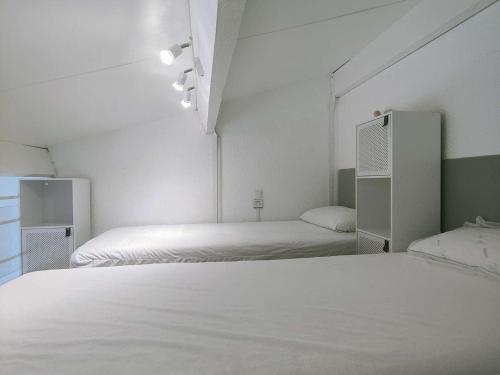 Cette chambre blanche comprend 2 lits. dans l'établissement Appartement T2 avec piscine et parking au Barcarès - FR-1-195-84, au Barcarès
