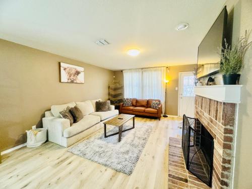 a living room with a couch and a fireplace at Charming Frisco Escape Minutes from PGA and The Star in Frisco