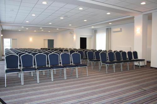 a room with a row of chairs in a room at Hotel George in Nadarzyn
