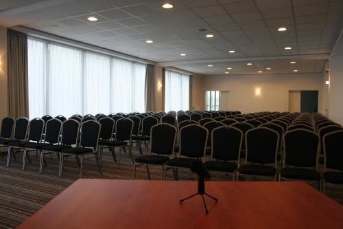 an empty room with chairs in a conference room at Hotel George in Nadarzyn