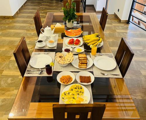 a long table with plates of food on it at RW Homestay in Wegala