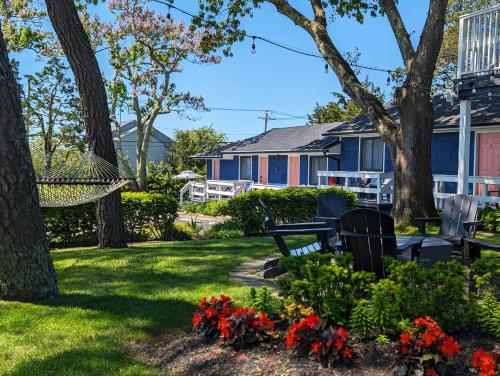 a yard with a bench and flowers at Ocean View Terrace in Hampton Bays