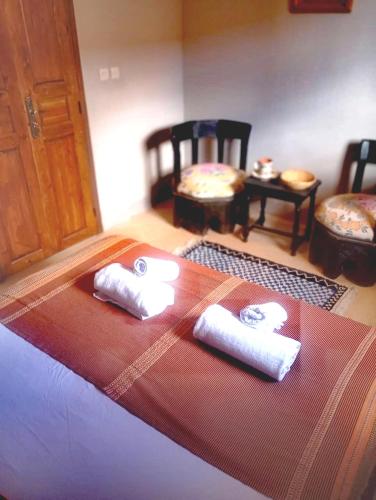 a room with three rolls of towels on a table at Dar INNÂ in Aït Benhaddou