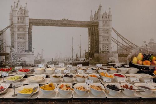 a buffet of food in front of the tower bridge at Hotel London 1889 & Casino in Batumi