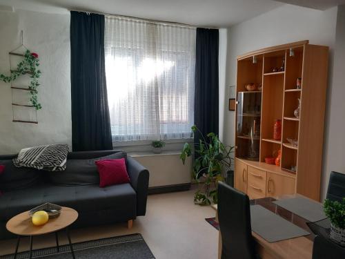 a living room with a couch and a table at Altstadt Oase Bernkastel-kues in Bernkastel-Kues