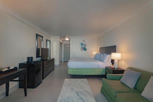 a hotel room with a bed and a couch at Catalonia Montego Bay - All Inclusive in Montego Bay