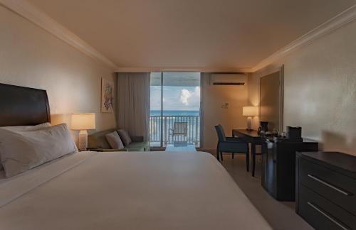 a hotel room with a bed and a desk with a view at Catalonia Montego Bay - All Inclusive in Montego Bay