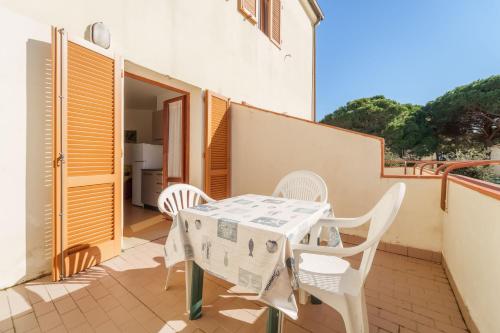 a patio with a table and chairs on a balcony at Appartamenti Gli Orizzonti - Goelba in Marina di Campo